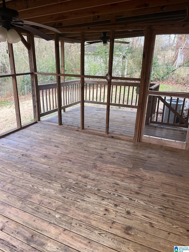 unfurnished sunroom featuring ceiling fan