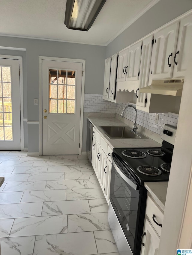 kitchen with electric stove, light countertops, marble finish floor, and white cabinetry