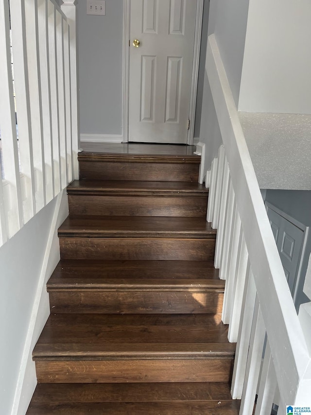 stairway with hardwood / wood-style floors