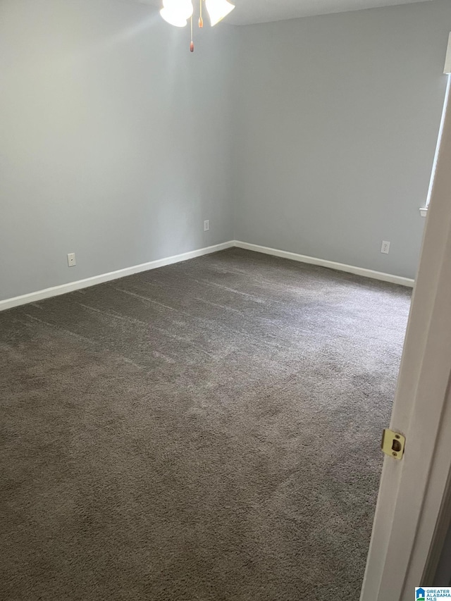 carpeted empty room featuring ceiling fan