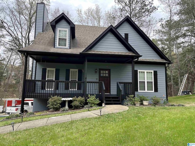 view of front facade featuring a porch, a front lawn, and a chimney