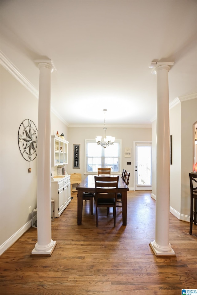 dining space with dark wood-type flooring, baseboards, plenty of natural light, and ornate columns