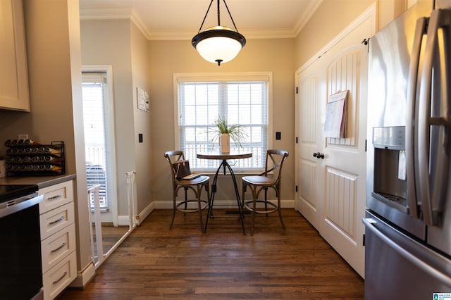 kitchen with range with electric stovetop, dark wood finished floors, baseboards, ornamental molding, and stainless steel fridge