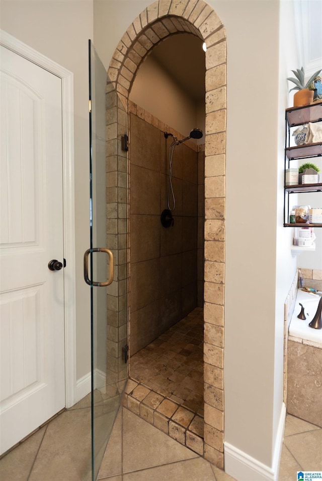 full bathroom with a shower stall and tile patterned floors