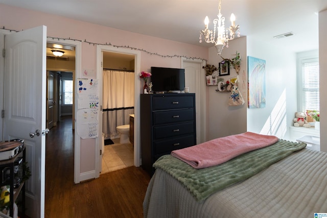 bedroom featuring an inviting chandelier, multiple windows, visible vents, and dark wood-style flooring