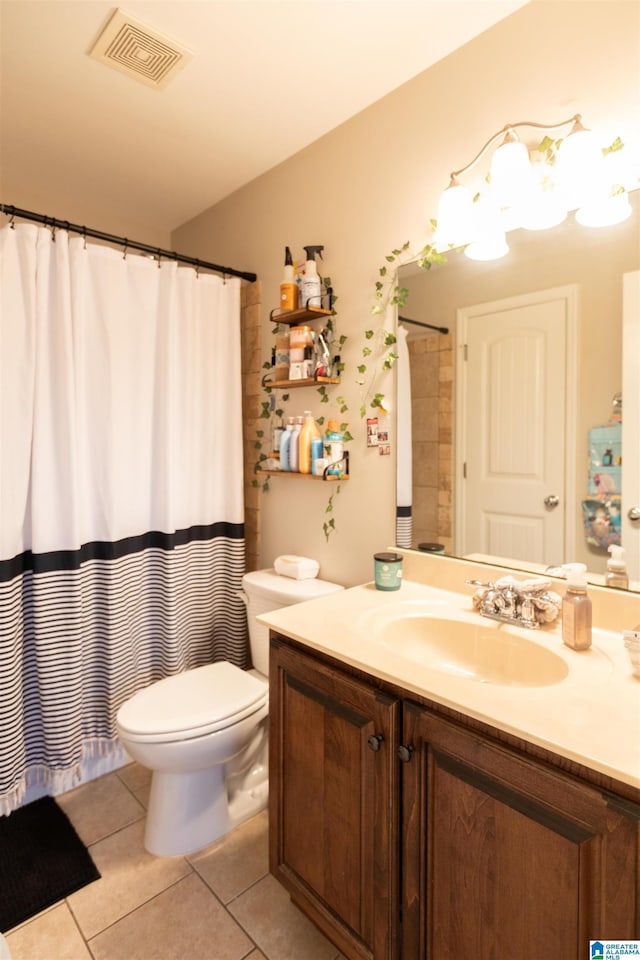 full bath featuring toilet, vanity, tile patterned flooring, and visible vents