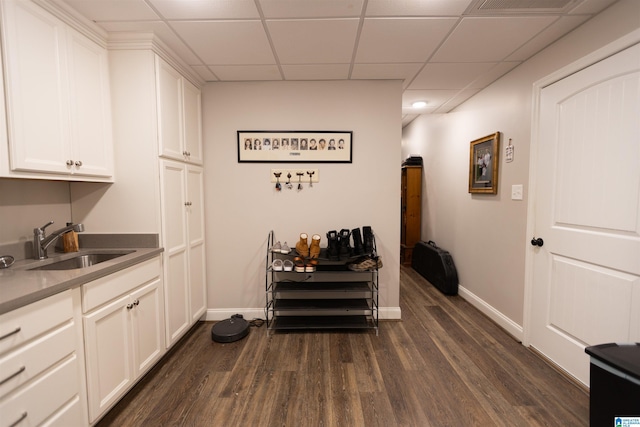 dining space featuring dark wood-style floors, visible vents, a paneled ceiling, and baseboards