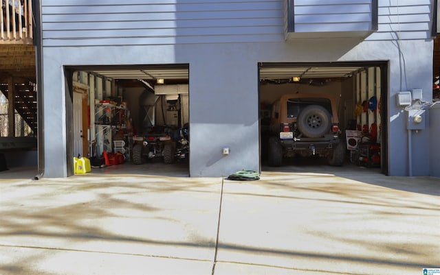 garage featuring concrete driveway