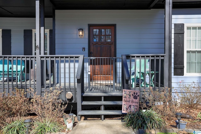 view of exterior entry with covered porch