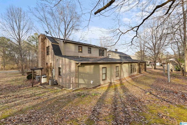 rear view of property with central AC unit