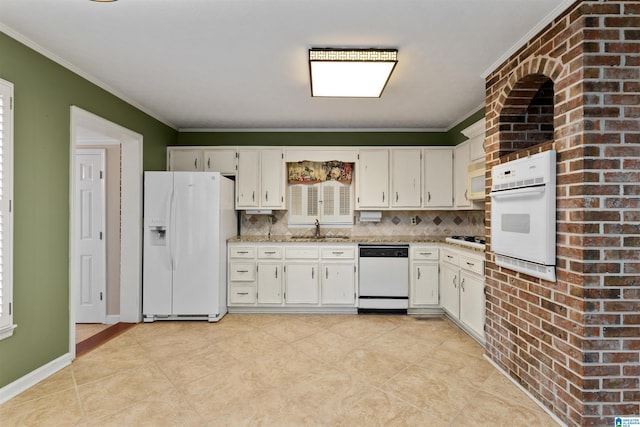 kitchen featuring white appliances, white cabinets, and crown molding