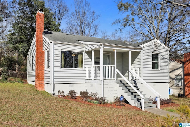 view of front of home featuring a front yard and a porch