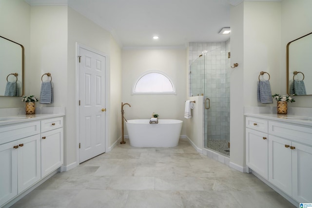 bathroom featuring a stall shower, a soaking tub, crown molding, and vanity