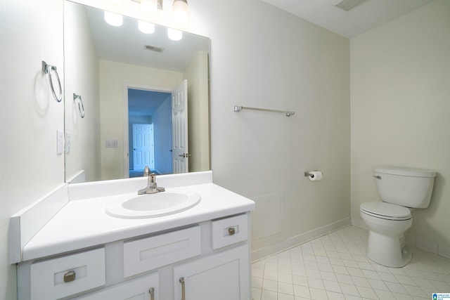 bathroom with toilet, visible vents, baseboards, vanity, and tile patterned floors