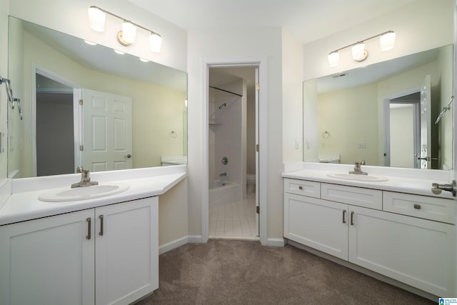 full bath with carpet floors, two vanities, a sink, and shower / bathing tub combination