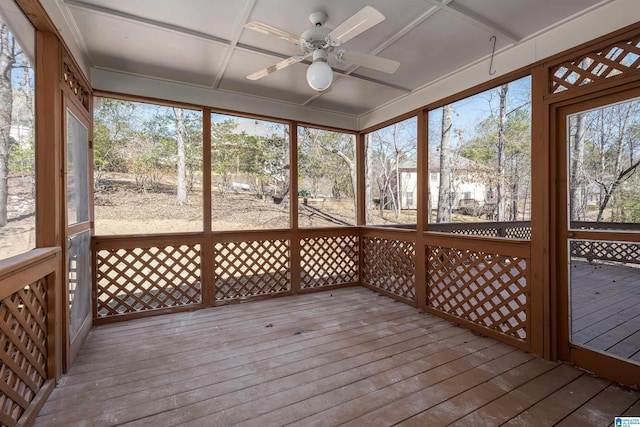 unfurnished sunroom featuring ceiling fan