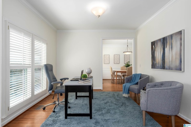 office space featuring ornamental molding, wood finished floors, and baseboards