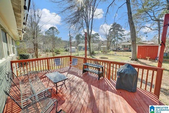 deck with a fenced backyard and a grill