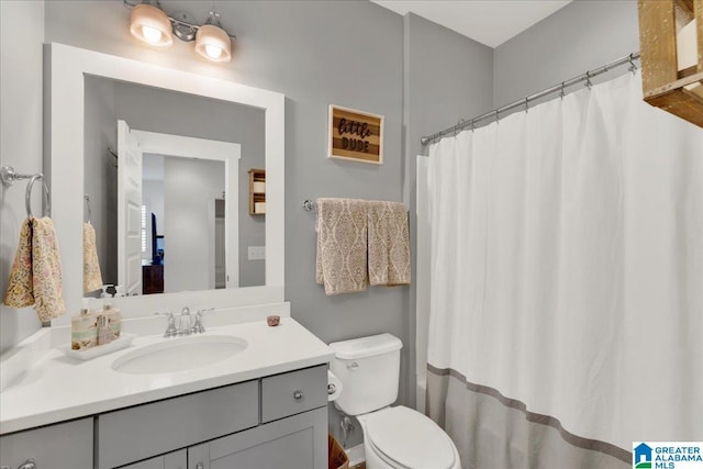 bathroom featuring vanity and toilet