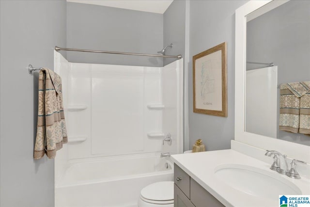 full bathroom featuring washtub / shower combination, vanity, and toilet