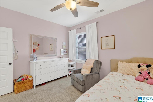 bedroom with light colored carpet, visible vents, and ceiling fan