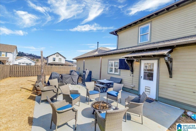 view of patio / terrace featuring an outdoor fire pit and fence