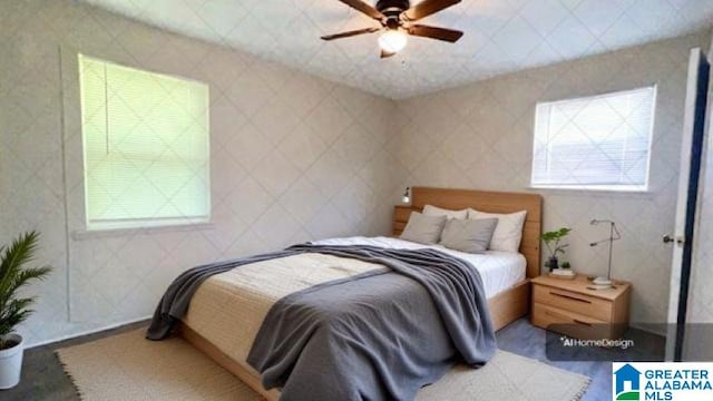 bedroom with multiple windows and ceiling fan