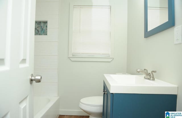 bathroom with a tub to relax in, toilet, and vanity