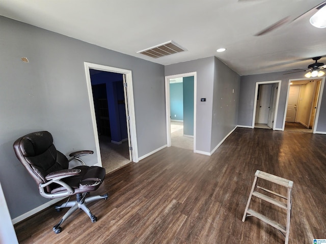 interior space with dark wood finished floors, visible vents, and baseboards