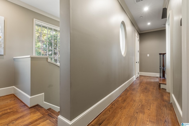 corridor featuring visible vents, baseboards, wood finished floors, an upstairs landing, and recessed lighting