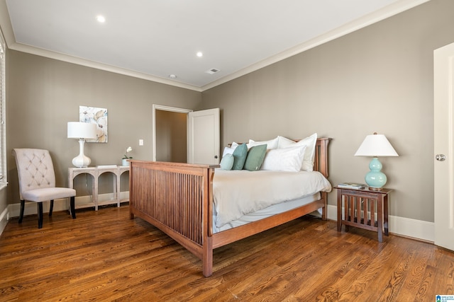 bedroom featuring dark wood-style floors, visible vents, baseboards, and crown molding