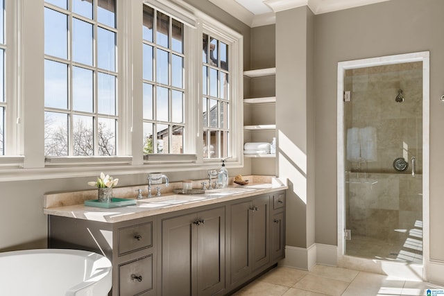 bathroom featuring a shower stall, vanity, baseboards, and tile patterned floors