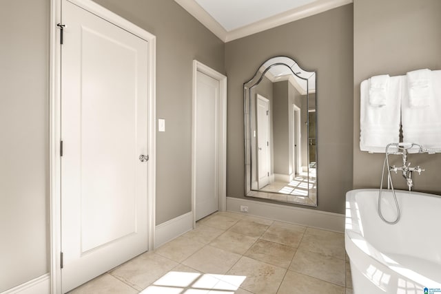 bathroom featuring a soaking tub, tile patterned flooring, and baseboards