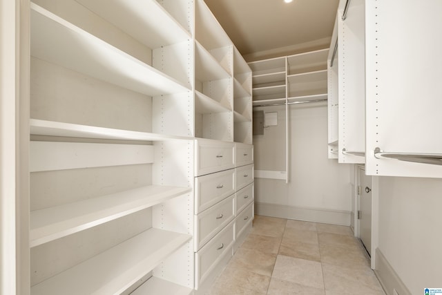 walk in closet featuring light tile patterned floors