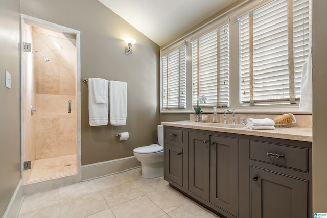 bathroom featuring baseboards, lofted ceiling, tile patterned floors, vanity, and a shower stall