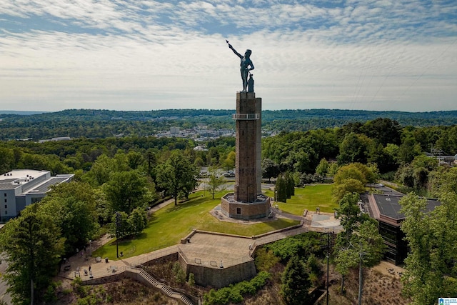 drone / aerial view featuring a wooded view