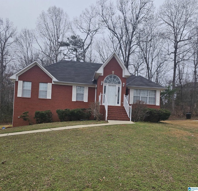 view of front of property with a front lawn and brick siding