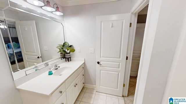 bathroom featuring vanity, baseboards, and tile patterned flooring