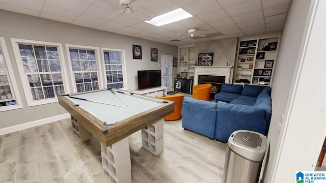 rec room with billiards, light wood-style floors, a fireplace, a paneled ceiling, and ceiling fan