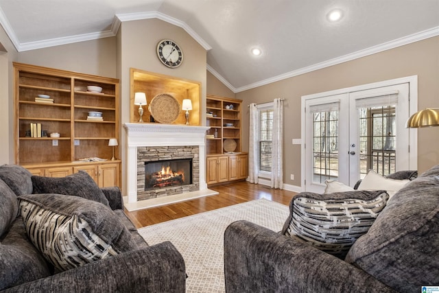 living room featuring ornamental molding, vaulted ceiling, and french doors