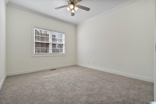 carpeted spare room featuring baseboards, ceiling fan, and ornamental molding