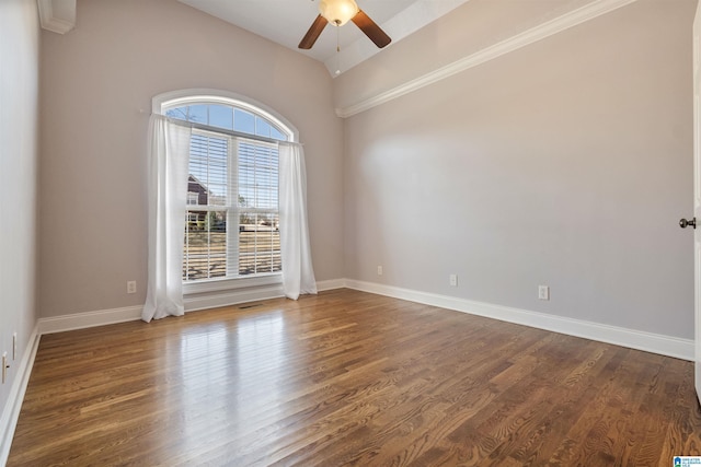 unfurnished room featuring dark wood finished floors, baseboards, lofted ceiling, and ceiling fan