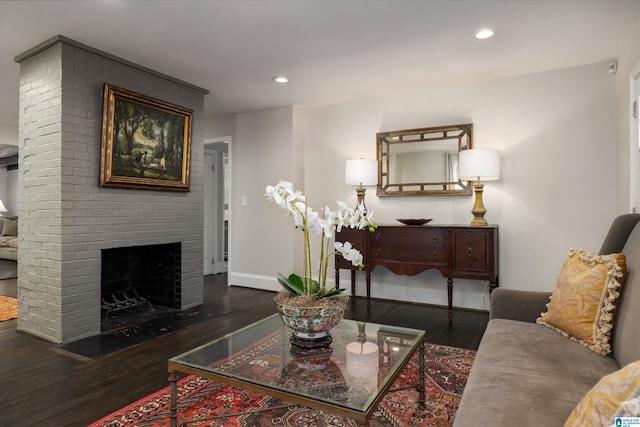 living room featuring dark wood-type flooring, recessed lighting, a fireplace, and baseboards