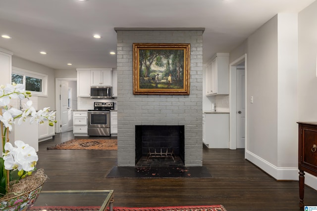 living room featuring recessed lighting, a brick fireplace, baseboards, and dark wood-style flooring