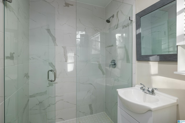 bathroom with a stall shower and vanity