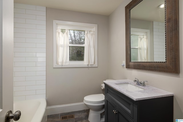 bathroom featuring shower / bathtub combination, visible vents, toilet, vanity, and baseboards