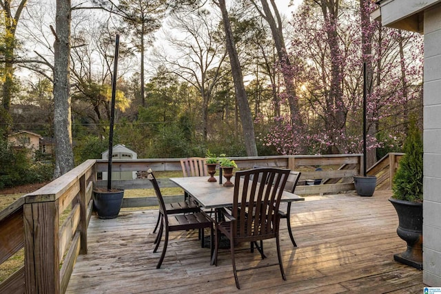 wooden terrace featuring outdoor dining area