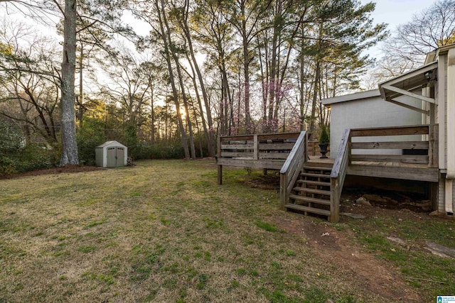 view of yard with a deck, a shed, stairway, and an outdoor structure