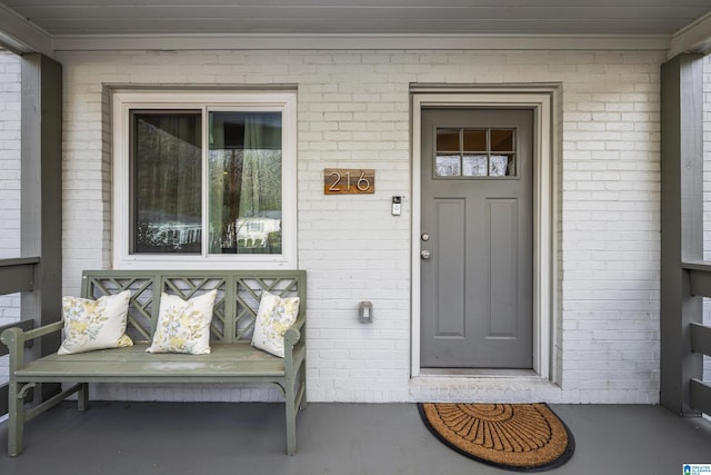 doorway to property with brick siding