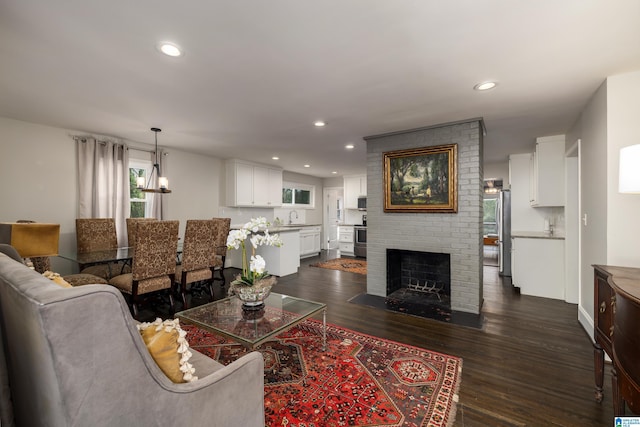 living room featuring a fireplace, dark wood finished floors, and recessed lighting